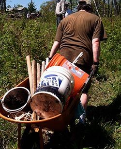 volunteer hauling suplies at the main AQRT Center