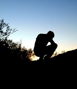 man bowing down in surrender